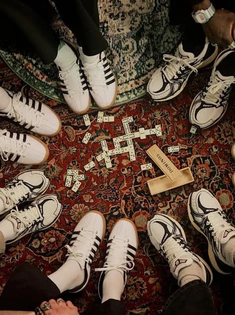 Groupe portant des sneakers K-Swiss autour d'une partie de dominos